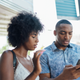 Black couple looking at phone
